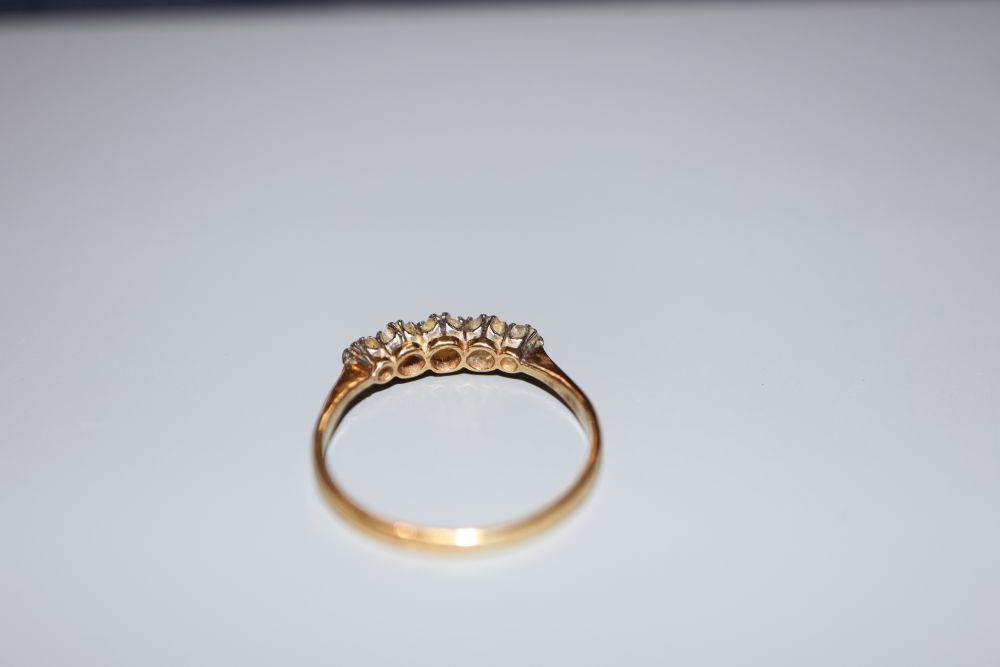 An 18ct gold and graduated five stone diamond ring, size P, gross 2.1 grams.